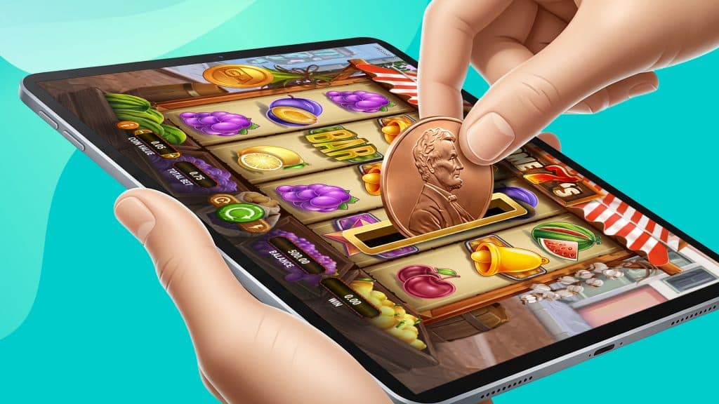 Awesome 7s, a penny slot, is played on an iPad as someone inserts a penny into the coin slot to operate the game.