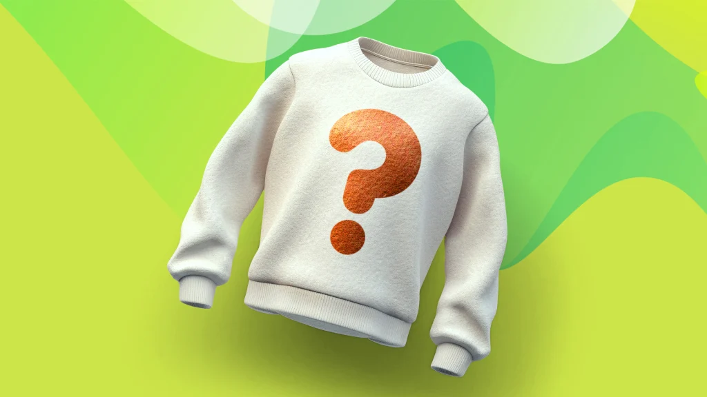 A sweater with a printed question mark is against a green background.