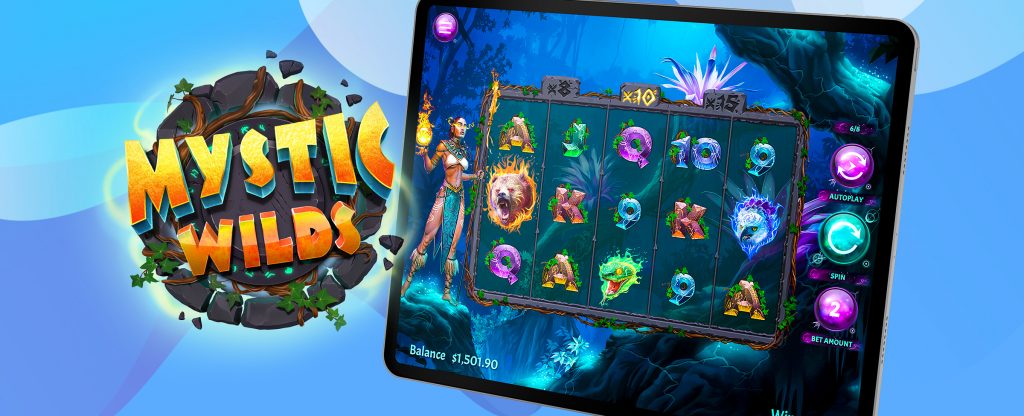 Sebuah iPad ditampilkan dalam gambar ini yang menampilkan pratinjau permainan slot Mystic Wilds di SlotsLV, sedangkan di sebelah kiri, logo dari permainan yang sama terlihat.