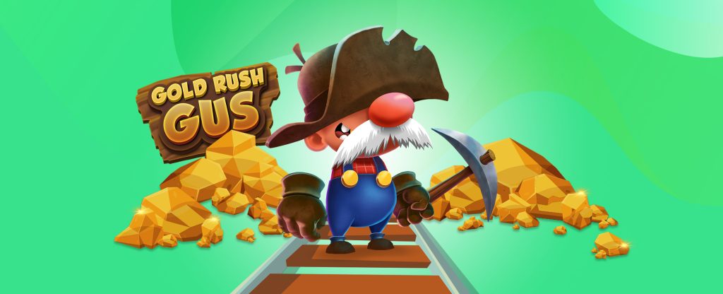 Di tengah gambar ini, kita melihat karakter dan logo animasi 3D sentral dari game slot SlotsLV, Gold Rush Gus.  Gus berdiri di tengah rel;  dia memiliki kumis besar dan hidung merah, dan memakai topi prospektif yang terlalu besar, memegang beliung di tangannya.  Di belakangnya ada dua gundukan besar emas, dengan papan kayu di belakang salah satunya bertuliskan Gold Rush Gus. 