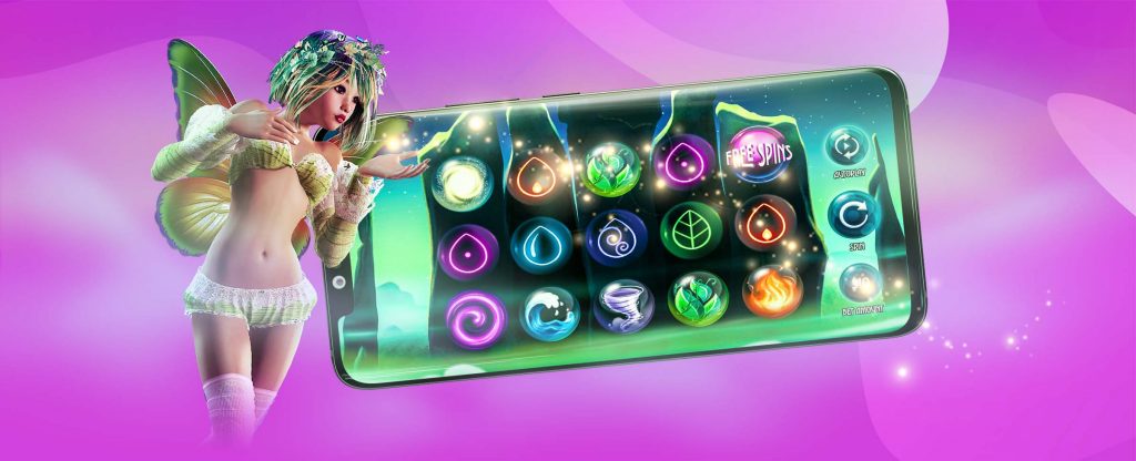 A mystical fairy with glowing wings and a floral crown stands beside a large smartphone screen displaying the Mystic Elements slot game. The reels feature elemental symbols of fire, water, air, and earth, set against an ethereal green and purple background.